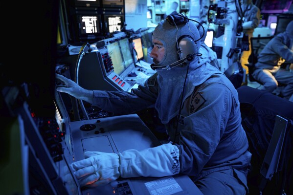 In this image provided by the U.S. Navy, Chief Fire Controlman (Aegis) Kenneth Krull, assigned to the USS Carney (DDG 64), mans the combat systems coordinator console in the combat information center during a general quarters drill on Oct. 14, 2023, in the Eastern Mediterranean. The warship sailing near the Bab el-Mandeb Strait shot down a drone launched from Yemen on Wednesday, Nov. 29, the U.S. military said, in the latest in a string of threats from Iranian-backed Houthi rebels. The USS Carney downed the drone, a Iranian-made KAS-04, which was launched from a Houthi-controlled area of Yemen and was heading toward the ship. (Mass Communication Specialist 2nd Class Aaron Lau/U.S. Navy via AP)