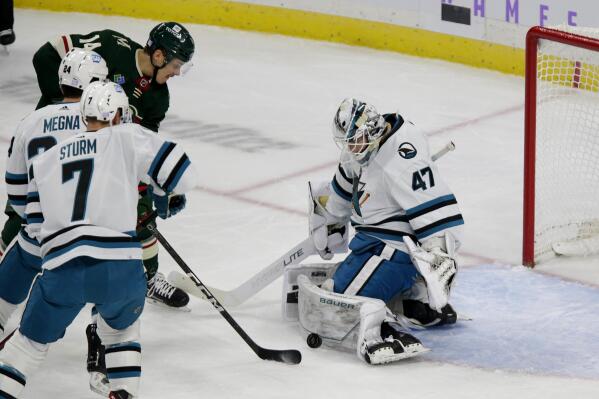 Minnesota Wild center Joel Eriksson Ek is stopped by San Jose Sharks goaltender James Reimer (47) with Sharks' Jaycob Megna and Nico Sturm (7) looking on in the first period of an NHL hockey game, Sunday, Nov. 13, 2022, in St. Paul, Minn. (AP Photo/Andy Clayton-King)