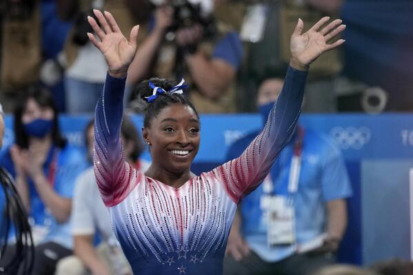 Simone Biles, of the United States, waves after performing on the balance beam during the artistic gymnastics women's apparatus final at the 2020 Summer Olympics, Tuesday, Aug. 3, 2021, in Tokyo, Japan. (AP Photo/Ashley Landis)