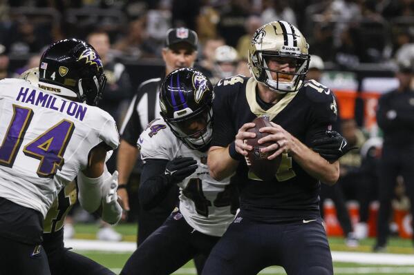 Baltimore Ravens cornerback Marlon Humphrey (44) is sacked New Orleans Saints quarterback Andy Dalton (14), with Baltimore Ravens safety Kyle Hamilton nearby in the second half of an NFL football game in New Orleans, Monday, Nov. 7, 2022. (AP Photo/Butch Dill)