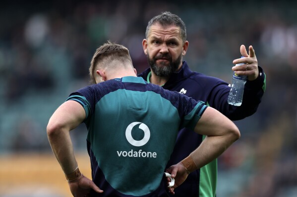 Ireland's head coach Andy Farrell chats with his player before the start for the Six Nations rugby union international match between England and Ireland, at Twickenham stadium, London Saturday, March 9, 2024. (AP Photo/Ian Walton)