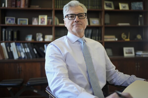 Judge Juan Merchan poses for a picture in his chambers in New York, Thursday, March 14, 2024. Merchan is poised to become the first judge ever to oversee a former U.S. president’s criminal trial. He's presiding over Donald Trump’s hush money case in New York. (AP Photo/Seth Wenig)