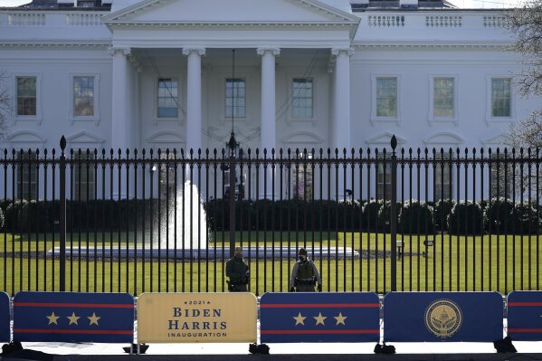 A security team patrols in front of the White House as preparations continue ahead of President-elect Joe Biden's inauguration ceremony, Tuesday, Jan. 19, 2021, in Washington. (AP Photo/David Phillip)
