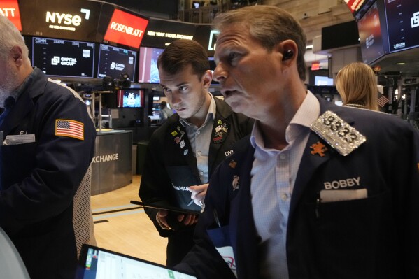 Traders work on the floor of the New York Stock Exchange, Tuesday, March 11, 2025. (AP Photo/Richard Drew)
