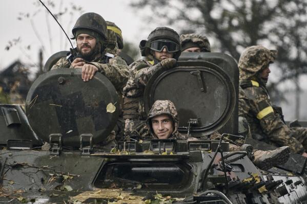 Ukrainian soldiers ride an APC in Donetsk region, Ukraine, Thursday, Oct. 20, 2022. (AP Photo/LIBKOS)