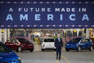 FILE - President Joe Biden arrives to speak during a visit to the General Motors Factory ZERO electric vehicle assembly plant, Wednesday, Nov. 17, 2021, in Detroit. Some Tesla fans and Elon Musk have picked an online fight with Biden over the company being left out as Biden touts EVs as a solution to climate change. “For reasons unknown," Musk tweeted Sunday, Jan. 30, 2022, referring to the president, “@potus is unable to say the word ‘Tesla.'” (AP Photo/Evan Vucci, File)