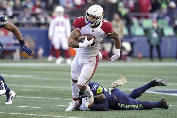 Arizona Cardinals running back James Conner carries as Seattle Seahawks' Jordyn Brooks defends during the first half of an NFL football game, Sunday, Nov. 21, 2021, in Seattle. (AP Photo/Ted S. Warren)