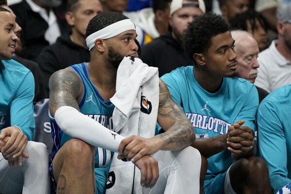 Charlotte Hornets forward Miles Bridges watches from the bench during the second half of an NBA basketball game against the New York Knicks on Saturday, Nov. 18, 2023, in Charlotte, N.C. (AP Photo/Chris Carlson)