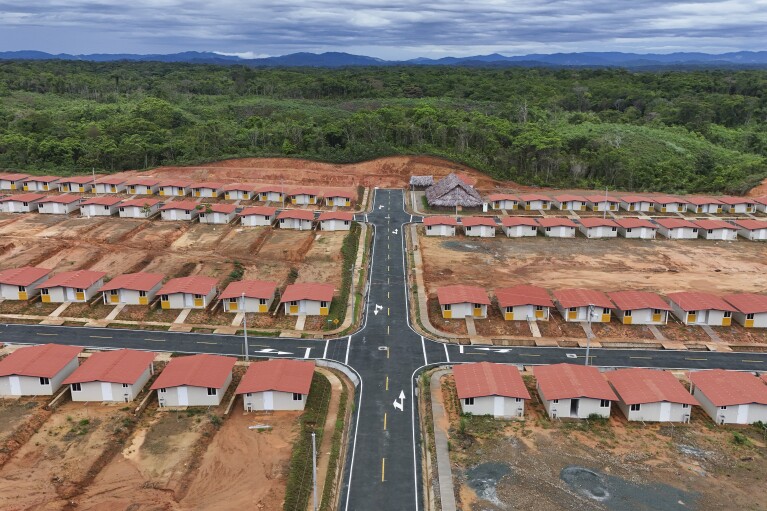 New homes stand in Nuevo Carti on Panama's Caribbean coast, Monday, May 27, 2024. Due to rising sea levels, about 300 Guna Indigenous families will relocate from Gardi Sugdub Island, part of the San Blas archipelago, to new homes built by the government on the mainland. (AP Photo/Matias Delacroix)