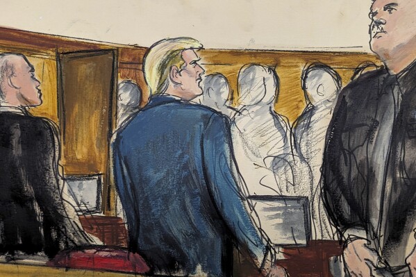 Donald Trump stands as the jury files into the courtroom at the start of the trial in Manhattan criminal court Monday, April 22, 2024, in New York. (Elizabeth Williams via AP)