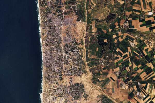 This satellite photo from Planet Labs PBC shows the Gaza Strip on Tuesday, Jan 30, 2024. Satellite photos show new demolition along a 1-kilometer-deep path on the Gaza Strip's border with Israel, according an analysis by The Associated Press and expert reports. The destruction comes as Israel has said it wants to establish a buffer zone there, further tearing away at land the Palestinians want for a state over international objections. (Planet Labs PBC via AP)