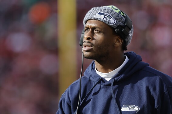 Injured Seattle Seahawks quarterback Geno Smith watches from the sidelline during the first half of an NFL football game against the San Francisco 49ers in Santa Clara, Calif., Sunday, Dec. 10, 2023. (AP Photo/Josie Lepe)