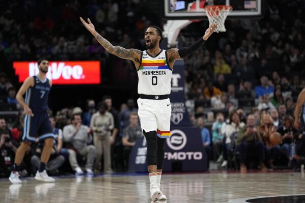 Minnesota Timberwolves guard D'Angelo Russell (0) celebrates after a three-point basket by forward Nathan Knight (13) during the first half of an NBA basketball game against the Memphis Grizzlies, Friday, Jan. 27, 2023, in Minneapolis. (AP Photo/Abbie Parr)