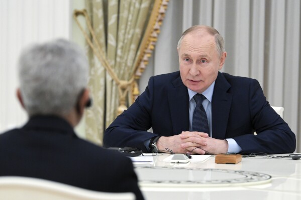 Russian President Vladimir Putin speaks to India's Foreign Minister Subrahmanyam Jaishankar, back to a camera, during their meeting at the Kremlin in Moscow, Russia, Wednesday, Dec. 27, 2023. (Alexei Nikolsky, Sputnik, Kremlin Pool Photo via AP)