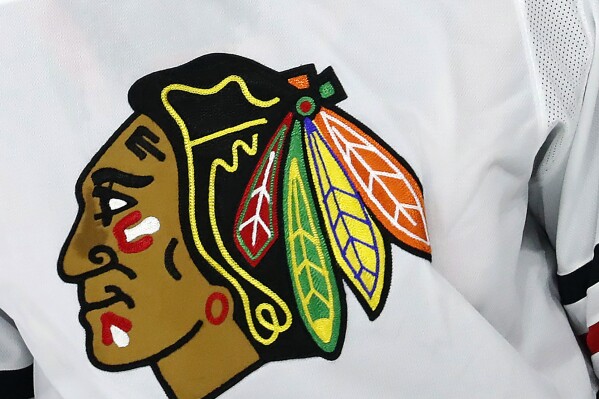 FILE - The Chicago Blackhawks logo adorns a jersey in Raleigh, N.C., May 3, 2021. A former hockey player in the Blackhawks organization has alleged in a lawsuit the team's former video coach sexually assaulted him during the 2009-10 season and the Blackhawks responded inadequately to his complaint because it did not want a disruption during its Stanley Cup run. (AP Photo/Karl B DeBlaker, File)