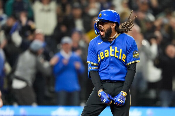 Seattle Mariners' J.P. Crawford celebrates his grand slam against the Texas Rangers during the fourth inning of a baseball game Friday, Sept. 29, 2023, in Seattle. (AP Photo/Lindsey Wasson)