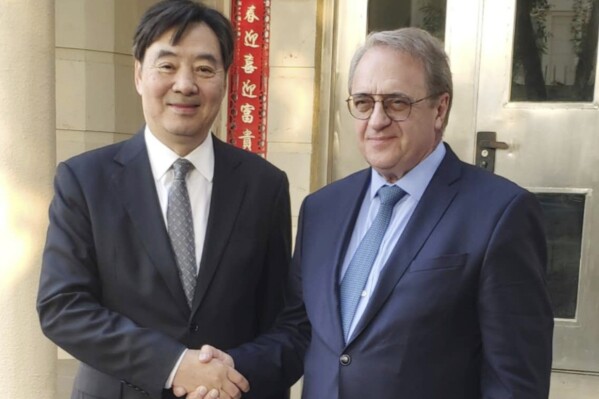 In this photo provided by the Chinese Embassy in Qatar via Xinhua News Agency, Zhai Jun, left, special envoy of the Chinese government on the Middle East issue, meets with Russia's Deputy Foreign Minister and Special Presidential Representative for the Middle East and Africa Mikhail Bogdanov in Doha, Qatar, Thursday, Oct. 19, 2023. (Chinese Embassy in Qatar/Xinhua via AP)