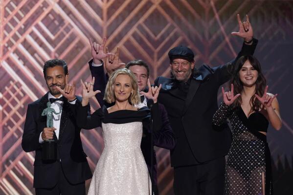 The cast of "Coda" accepts the award for outstanding performance by a cast in a motion picture and signs "I love you" at the 28th annual Screen Actors Guild Awards at the Barker Hangar on Sunday, Feb. 27, 2022, in Santa Monica, Calif. (AP Photo/Chris Pizzello)
