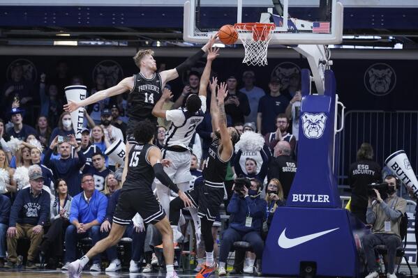 Butler's Aaron Thompson (2) has his shot blocked by Providence's Noah Horchler (14) during the second half of an NCAA college basketball game, Sunday, Feb. 20, 2022, in Indianapolis. Providence won 71-70 in overtime. (AP Photo/Darron Cummings)