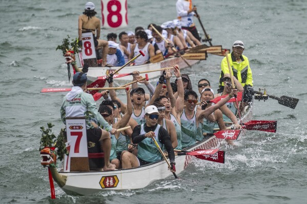 Competitors cheer after a race in the Stanley International Dragon Boat Championships to celebrate the Dragon Boat Festival in Hong Kong, Saturday, May 31, 2025. (AP Photo/Chan Long Hei)