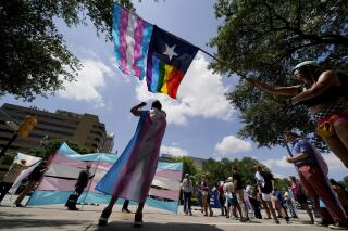 FILE - Demonstrators gather on the steps to the State Capitol to speak against transgender-related legislation bills being considered in the Texas Senate and Texas House, May 20, 2021 in Austin, Texas. No texts or emails that leave paper trails. Unusually close oversight. Texas child welfare workers who have quit over Republican Gov. Greg Abbott's first-of-its-kind directive in the U.S. to investigate families of transgender youth for abuse say rushed new protocols appear designed to tilt the outcome of cases from the outset and find parents at fault. (AP Photo/Eric Gay, File)