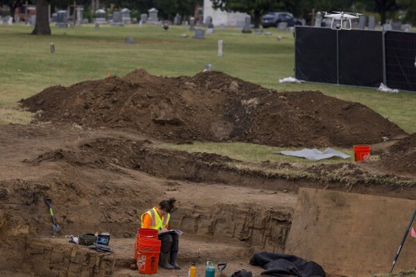 FILE - Researchers work in Oaklawn Cemetery as they search for victims of the 1921 Tulsa Race Massacre Tuesday, Sept. 12, 2023 in Tulsa, Okla. The latest search for remains of victims of the 1921 Tulsa Race Massacre has ended with 59 graves found and seven sets of remains exhumed. Oklahoma state archaeologist Kary Stackelbeck said excavation ended Friday, Sept. 29 with the exhumed remains taken to an onsite forensic laboratory to begin efforts to identify them and determine the causes of their deaths. (Mike Simons /Tulsa World via AP)