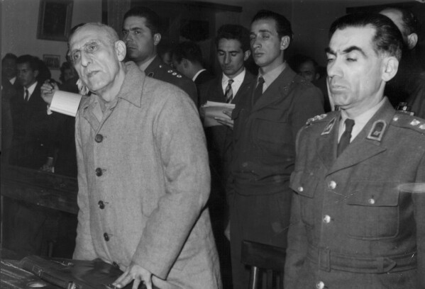 FILE - Former Iranian Prime Minister Mohammad Mosaddegh, left, is sentenced to three years solitary confinement by a military court after finding him guilty on 13 charges of acting against the shah, in Tehran, Iran on Dec. 21, 1953. In August 1953, a CIA-backed coup toppled Iran's prime minister, cementing the rule of Shah Mohammad Reza Pahlavi for over 25 years before the 1979 Islamic Revolution. (AP Photo, File)