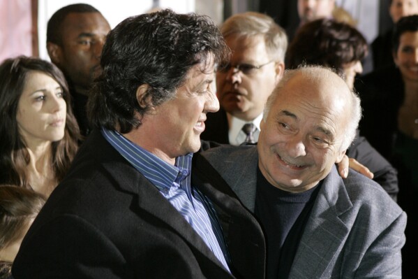 FILE - Sylvester Stallone, left, star of the movie "Rocky Balboa," and cast member Burt Young attend the film's premiere in Philadelphia, Dec. 18, 2006. Burt Young, the Oscar-nominated actor who played Paulie, the rough-hewn, mumbling-and-grumbling best friend, corner-man and brother-in-law to Sylvester Stallone in the “Rocky” franchise, has died. Young died Oct. 8, 2023 in Los Angeles. (AP Photo/Matt Rourke, File)