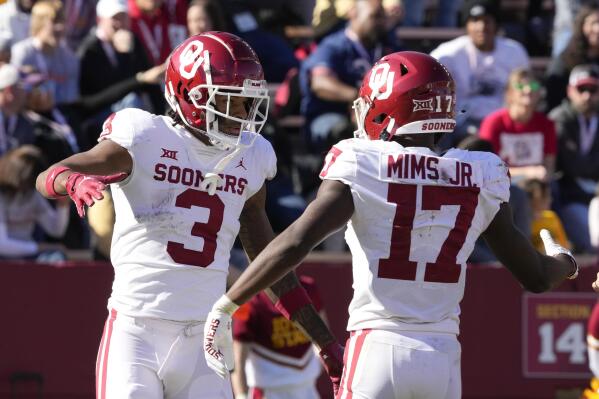 Oklahoma wide receiver Jalil Farooq (3) celebrates with teammate wide receiver Marvin Mims (17) after catching a 41-yard touchdown pass during the second half of an NCAA college football game against Iowa State, Saturday, Oct. 29, 2022, in Ames, Iowa. Oklahoma won 27-13. (AP Photo/Charlie Neibergall)