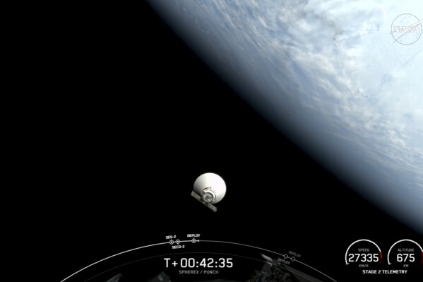 In this image taken from video released by SpaceX, NASA's newest space telescope, Spherex, drifts off into space after separating from a SpaceX rocket's upper stage after launching from Vandenberg Space Force Base, Calif., Tuesday, March 11, 2025. (SpaceX via AP)