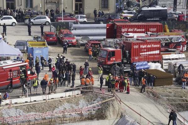 Rescue workers arrive at the scene of an accident at a construction site in Florence, Italy, Friday Feb. 16, 2024. An accident at a supermarket construction site in the Italian city of Florence on Friday killed at least one worker and left four others missing, officials said. (Marco Bucco/LaPresse via AP)