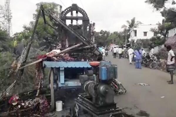 This image from video shows a truck, decorated as a chariot, after an accidental electric shock in Thanjavur district, in the southern Indian state of Tamil Nadu, Wednesday, April 27, 2022.Eleven people died from an accidental electric shock when the truck, decorated as a temple chariot, touched an overhead power transmission wire during a Hindu festival procession in southern India, police said. (KK Productions via AP)