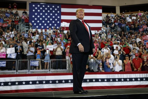 
              FILE - In this Oct. 10, 2018, file photo, President Donald Trump arrives to speak at a campaign rally at Erie Insurance Arena, in Erie, Pa. President Donald Trump's campaign rallies once had the feel of angry, raucous grievance sessions. More than 350 rallies later, gone is the darkness, the crackling energy, the fear of potential violence as supporters and protesters face off. Perish the thought, have Donald Trump's rallies gone mainstream? (AP Photo/Evan Vucci, File)
            