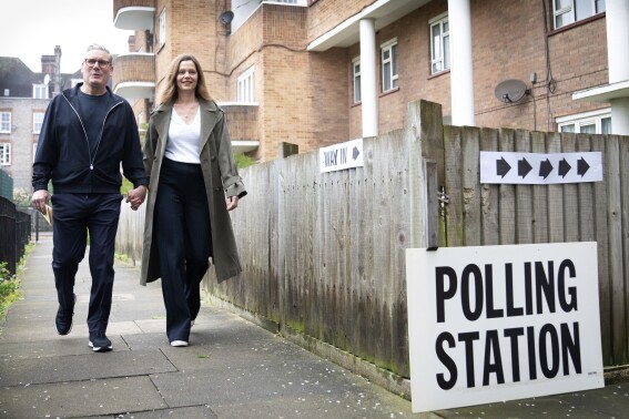 Labour leader Keir Starmer and his wife Victoria arrive at their local polling station to cast their vote in the local and London Mayoral election, in north London, Thursday, May 2, 2024. Millions of voters in England and Wales will cast their ballots on Thursday in an array of local elections that will be the last big test before a U.K. general election that all indicators show will see the Conservative Party ousted from power after 14 years. (Stefan Rousseau/PA Wire/PA via AP)