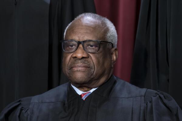 FILE - Associate Justice Clarence Thomas joins other members of the Supreme Court as they pose for a new group portrait, at the Supreme Court building in Washington, Oct. 7, 2022. The Supreme Court won’t have far to look for a personal take on the “crushing weight” of student debt that underlies the Biden administration’s college loan forgiveness plan. A legal challenge has reached the court and arguments are set for Tuesday. Thomas was in his mid-40s and in his third year on the nation's highest court when he paid off the last of his debt from his time at Yale Law School. (AP Photo/J. Scott Applewhite, File)