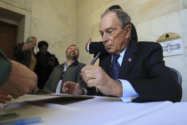 Former New York City Mayor Michael Bloomberg fills out paperwork, Tuesday, Nov. 12, 2019, at the state Capitol in Little Rock, Ark., to appear on the ballot in Arkansas' March 3 presidential primary. Bloomberg hasn't formally announced a bid for the Democratic presidential nomination, but his trip to Arkansas is the latest indication that he is leaning toward a run. (Staton Breidenthal/The Arkansas Democrat-Gazette via AP)