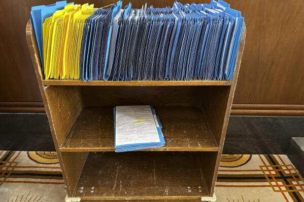 Hundreds of bills awaiting action in the Oregon Senate are held in a battered bookshelf on the Senate floor, unable to move forward to a vote because of a protest by Republicans, Tuesday, May 23, 2023 in Salem, Ore. The leader of Republican senators whose walkout of the Oregon Senate has prevented a quorum for almost three weeks said Tuesday, May 23, 2023, that they're not coming back until the very last day of the legislative session next month. (AP Photo/Andrew Selsky)