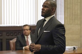 
              FILE - In this Friday, March 22, 2019 file photo, R. Kelly appears for a hearing at the Leighton Criminal Court Building in Chicago, Illinois. Dubai’s government on Sunday forcefully denied a claim by R&B singer R. Kelly that the artist had planned concerts in the sheikhdom after he had sought permission from an Illinois judge to travel here despite facing sexual-abuse charges. (E. Jason Wambsgans/Chicago Tribune via AP, Pool, File)
            