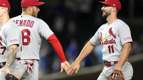 St. Louis Cardinals third baseman Nolan Arenado, left, and shortstop Paul DeJong celebrate the team's 7-2 win over the Chicago Cubs in a baseball game Thursday, July 20, 2023, in Chicago. (AP Photo/Charles Rex Arbogast)