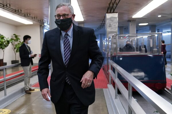 FILE - In this Feb. 12, 2021, file photo Sen. Richard Burr, R-N.C., walks on Capitol Hill in Washington on the fourth day of the second impeachment trial of former President Donald Trump. Of the seven Republicans, Burr’s vote to convict Trump was the most unexpected in the moment, and there were gasps in the chamber as he stood up declared his position. When the Capitol was attacked, Burr said in the statement, Trump “used his office to first inflame the situation instead of immediately calling for an end to the assault.” (AP Photo/Susan Walsh, File)