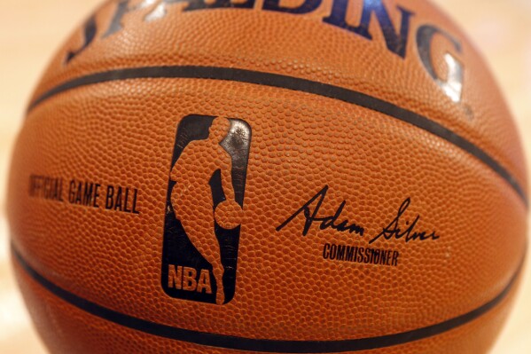 FILE - An NBA logo is seen on an official game ball before a basketball game, Feb. 1, 2014, in New York. The NBA said Wednesday, July 24, 2024 that it is not accepting Warner Bros. Discovery's $1.8 billion per year offer to continue its longtime relationship with the league and therefore has entered into a deal with Amazon Prime Video, a move that would mean this coming season would end a nearly four-decade run of games being on TNT. (ĢӰԺ Photo/Jason DeCrow, file)