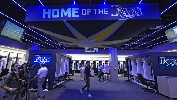Members of the media look around the Tampa Bay Rays clubhouse at George M. Steinbrenner Field during a stadium tour Wednesday, March 26, 2025, in Tampa, Fla. (AP Photo/Chris O'Meara)