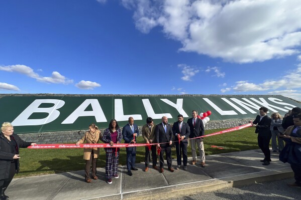 In this photo provided by the Office of the Mayor of New York, Mayor Eric Adams, third left, participates in the ribbon cutting ceremony and sign unveiling of Bally Links, formerly Trump Links, at Ferry Point in the Bronx borough of New York, Thursday, Jan. 11, 2024. (Michael Appleton/Mayoral Photography Office via AP)
