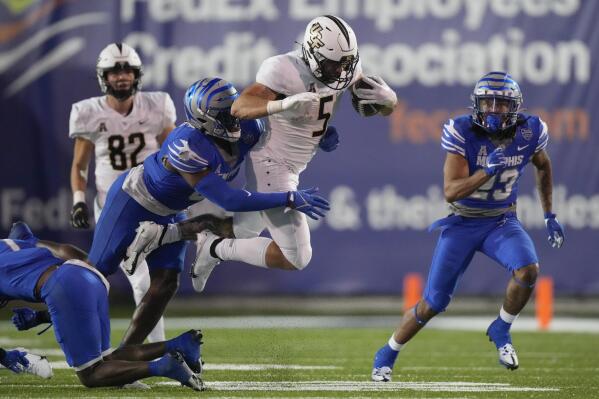 Central Florida running back Isaiah Bowser (5) is hit by Memphis linebacker Xavier Cullens in the second half of an NCAA college football game Saturday, Nov. 5, 2022, in Memphis, Tenn. (AP Photo/Mark Humphrey)