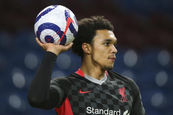 Liverpool's Trent Alexander-Arnold holds up the ball during the English Premier League soccer match between Burnley and Liverpool at Turf Moor in Burnley, England, Wednesday May 19, 2021. (Alex Livesey/Pool via AP)