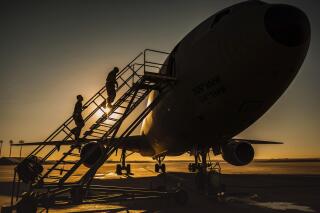 In this Jan. 5, 2021 photo from the U.S. Air Force, two KC-10 Extender crew chiefs board the aircraft at Al-Dhafra Air Base, United Arab Emirates. An Air Force KC-10 Extender that flew out of Al-Dhafra Air Base in the United Arab Emirates on Sunday, May 2, 2021, used the call sign "PIKLRICK" on a mission that saw it fly east out over the Gulf of Oman, according to flight-tracking data. The call sign appears to be a nod to an episode of the cartoon "Rick and Morty" in which one of the titular characters turns himself into a pickle to escape a family therapy session. (U.S. Air Force/Staff Sgt. Trevor T. McBride, via AP)