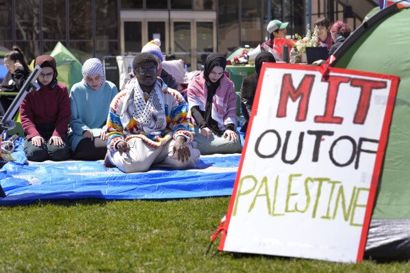 Massachusetts Institute of Technology student Isa Liggans, of Odenton, Md., front left, takes part in Muslim prayer with others Monday, April 22, 2024, at an encampment of tents at MIT, in Cambridge, Mass. (AP Photo/Steven Senne)