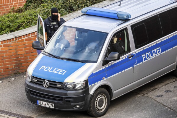 Police officers stand at the entrance of the district court, in Verden, Germany, Tuesday, Feb. 27, 2024. The former terrorist of the Red Army Faction (RAF), Daniela Klette (65), has been arrested in Berlin. (Sina Schuldt/dpa via AP)