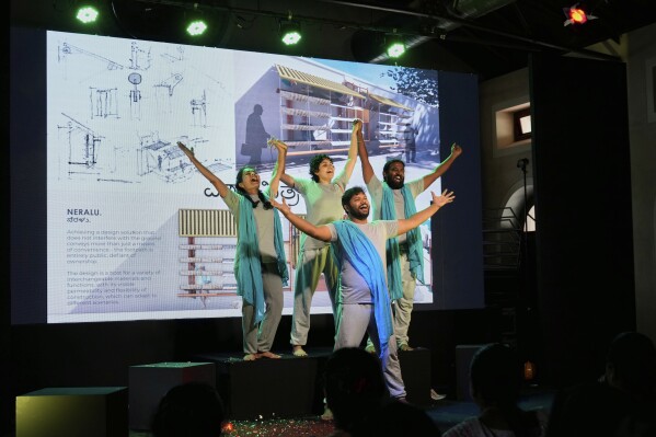 A group of theater artists perform to highlight the benefits of Neralu, an innovative portable heat shelter, at the Sweat and Concrete 2025 event in Bengaluru, India, Thursday, May 29, 2025. (AP Photo/Aijaz Rahi)