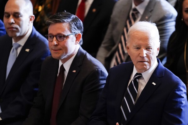 President Joe Biden, with from left, House Minority Leader Hakeem Jeffries, D-N.Y., and House Speaker Mike Johnson of La., listen during the National Prayer Breakfast, Thursday, Feb. 1, 2024, at the Capitol in Washington. (AP Photo/J. Scott Applewhite)